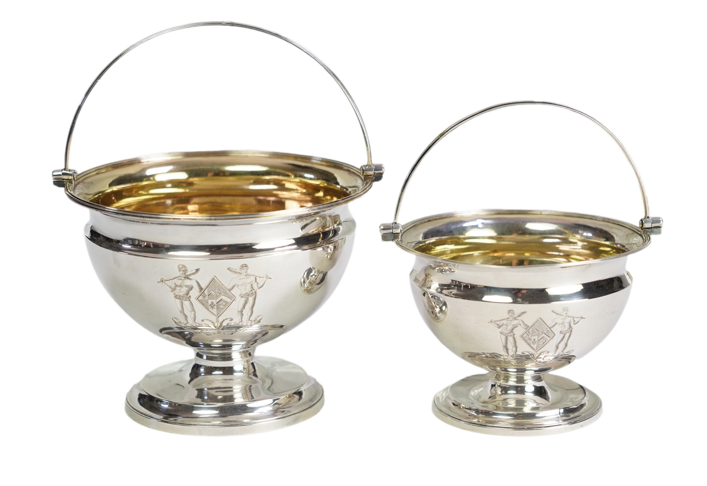 Two George III graduated silver pedestal sugar baskets, by James Darquits